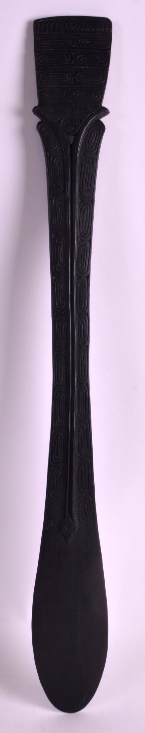 AN EARLY 20TH CENTURY CARVED EBONISED WOOD SPATULA probably Massim Culture, New Guinea, the top