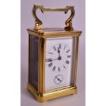 AN EARLY 20TH CENTURY BRASS CARRIAGE CLOCK with subsidiary dial. 6.5ins high including handle.