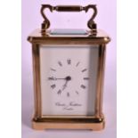 A GOOD BRASS CARRIAGE CLOCK by Charles Frodsham, with cream dial. 7.75ins high.