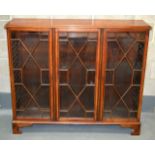 A MID 19TH CENTURY MAHOGANY BOOKCASE with triple glazed doors.