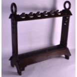 AN ARTS AND CRAFTS CARVED WOOD STICK STAND with floral cut decoration.