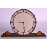 AN UNUSUAL 1950S RETRO SWISS MANTEL CLOCK with flat circular dial upon a rectangular base. 8.5ins