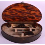 AN ART DECO TORTOISESHELL VANITY BOX opening to reveal a fitted interior. 9Ins wide.