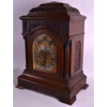 A HUGE VICTORIAN CARVED OAK BRACKET CLOCK by Sir John Bennett Ltd, with wall mount, profusely carved