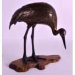 A 19TH CENTURY JAPANESE MEIJI PERIOD COLD PAINTED BRONZE HERON modelled upon a carved rootwood base.