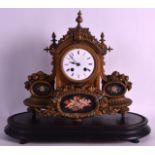 A 19TH CENTURY FRENCH GILT METAL AND PORCELAIN MANTEL CLOCK with black painted porcelain panels. 1Ft