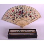 A FINE 19TH CENTURY CARVED IVORY FAN opening to reveal a well carved ivory panel of a figure, the