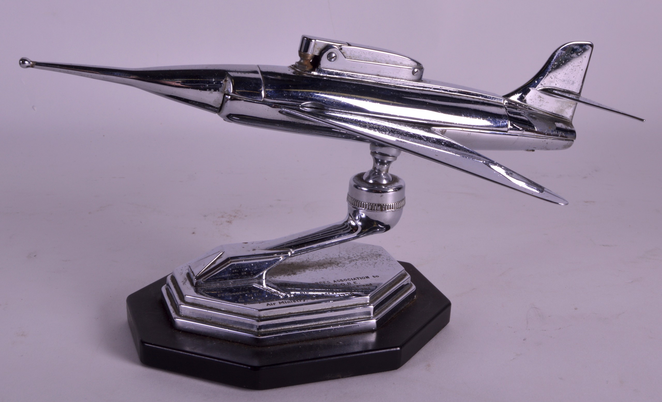 A VINTAGE PRESENTATION CHROME TABLE LIGHTER in the form of a plane. 9Ins wide.