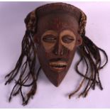 AN EARLY 20TH CENTURY AFRICAN CARVED WOOD MASK Mwana Pwo, modelled with elongated features. 9.5ins