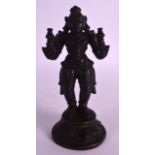 A 17TH/18TH CENTURY INDIAN BRONZE FIGURE OF A BUDDHISTIC GOD modelled holding two utensils within