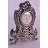 A GOOD MINIATURE 19TH CENTURY EUROPEAN SILVER CLOCK with pierced foliage panels and white painted