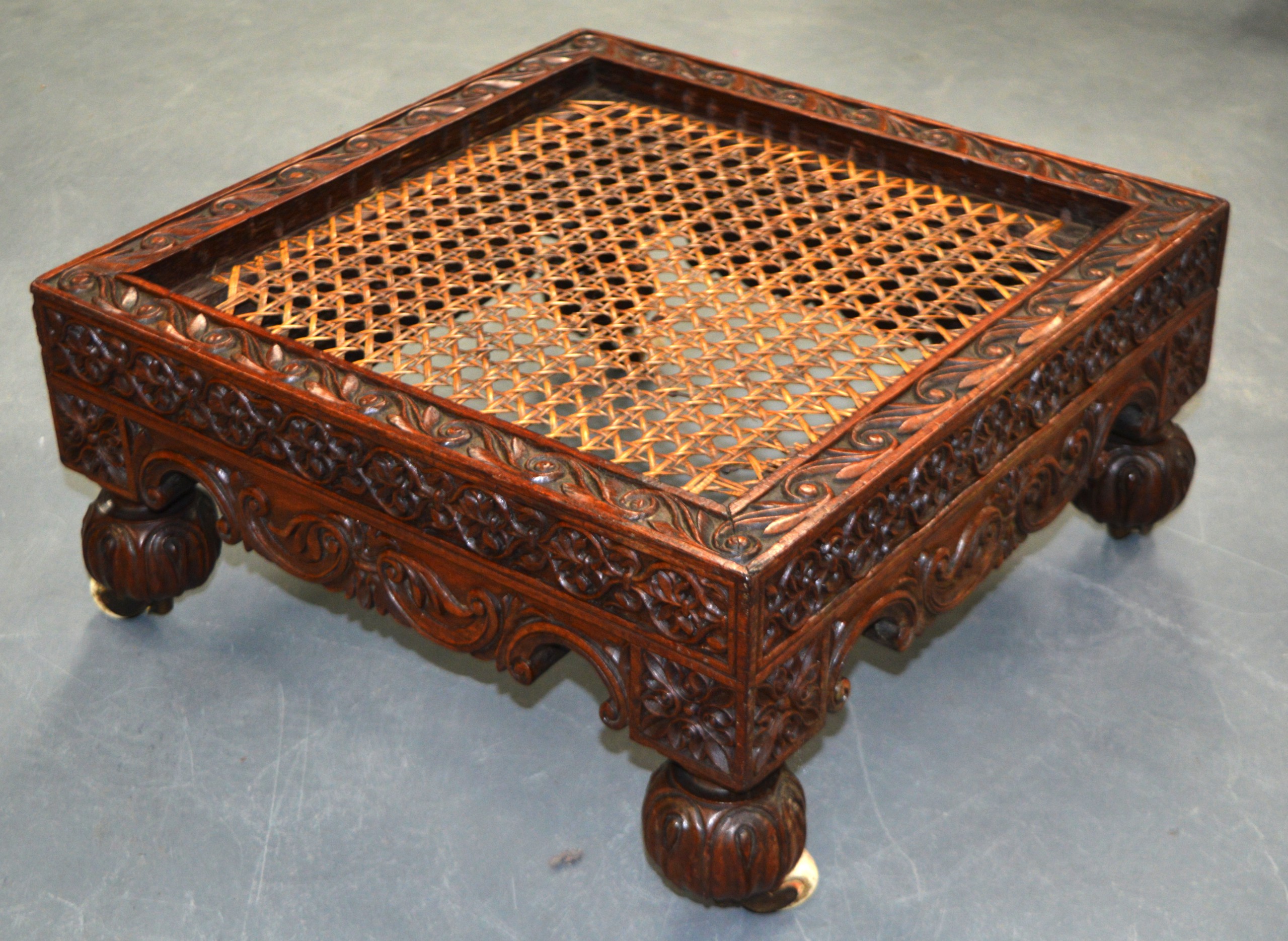 A GOOD 19TH CENTURY ANGLO INDIAN CARVED WOOD STOOL with profusely carved scrolling vines. 1Ft 5ins