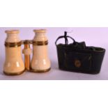 A GOOD PAIR OF VICTORIAN CARVED IVORY OPERA GLASSES by Negretti and Zambra, within a leather case.