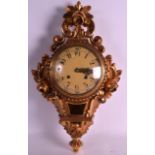 A 19TH CENTURY FRENCH GILTWOOD CARVED CARTEL CLOCK with cream dial and acanthus capped frame. 1Ft