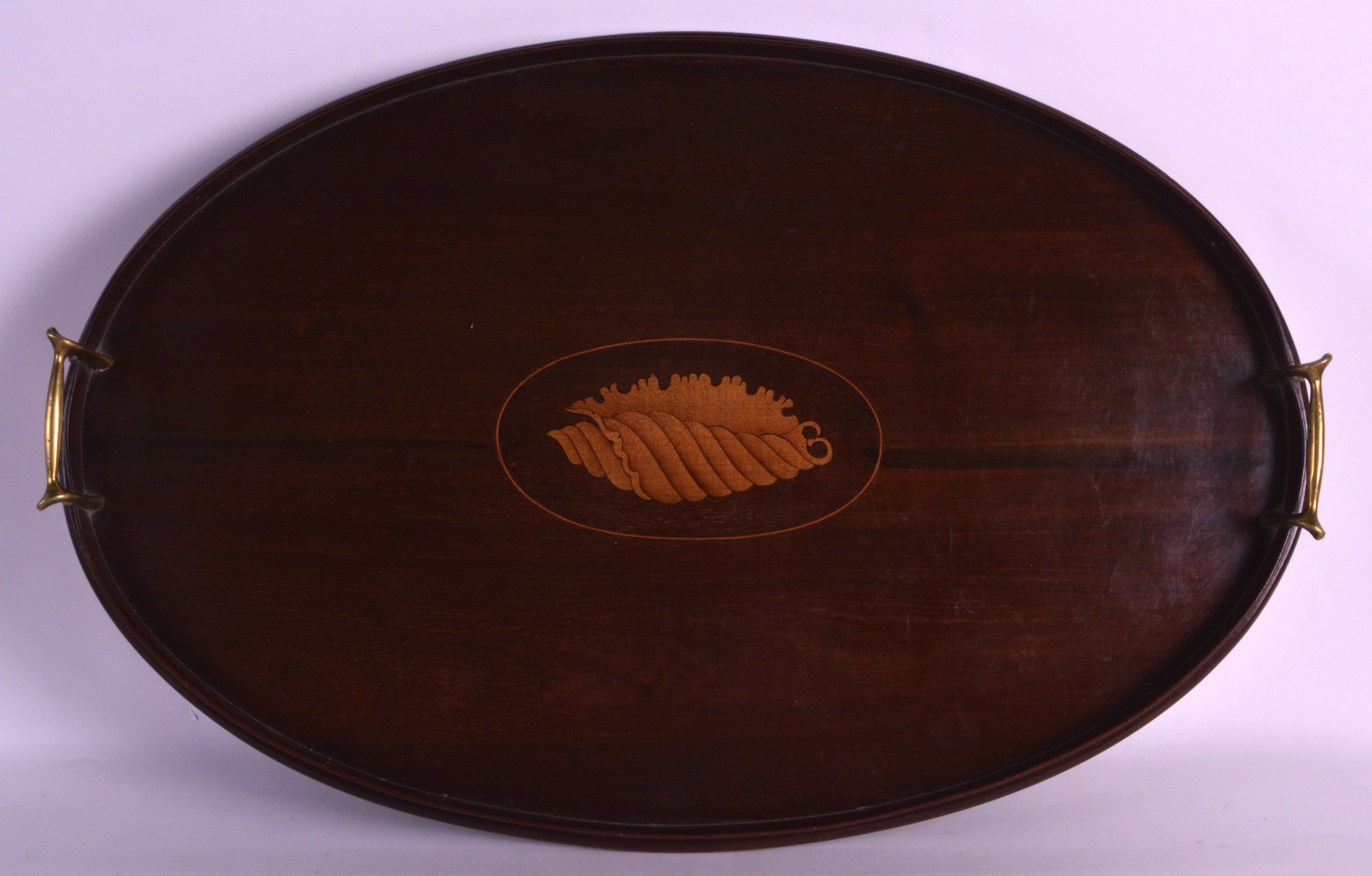 AN EDWARDIAN MAHOGANY TEA TRAY inset with a panel of shell. 1Ft 8ins wide.