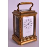 A MINIATURE 19TH/20TH CENTURY CARRIAGE CLOCK with white enamel dial, painted with black numerals.