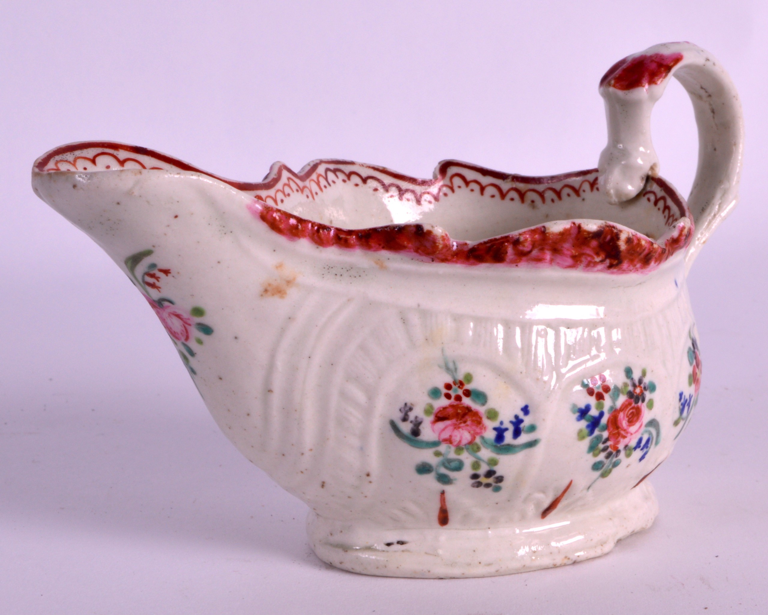 AN UNUSUAL 18TH CENTURY LIVERPOOL CREAMBOAT with serpant biting handle, painted with flowers. 5Ins