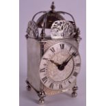 A RARE ENGLISH SILVER HALLMARKED LANTERN CLOCK formed with pieced panels, the dial engraved with