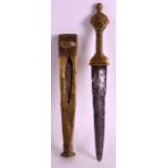 AN EARLY 20TH CENTURY AFRICAN DAGGER with decorated brass scabbard and grip, the blade with faint