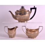 A VICTORIAN THREE PIECE SILVER TEASET with reeded lower body. London 1888. 15oz. (3)