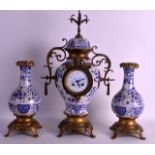 A 19TH CENTURY DELFT MOUNTED GILT METAL CLOCK GARNITURE painted with flowers and landscapes.