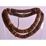 AN EARLY 20TH CENTURY CARVED SNAKE VERTEBRAE NECKLACE possibly Amazonian, with coral fittings. 2Ft