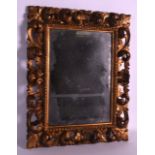 AN 18TH/19TH CENTURY ITALIAN FLORENTINE GILTWOOD MIRROR with scrolling foliate frame. 1Ft 7ins x 1ft