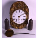 A MID 19TH CENTURY FRENCH BRASS VINEYARD CLOCK with twin weight movement and white enamel dial.