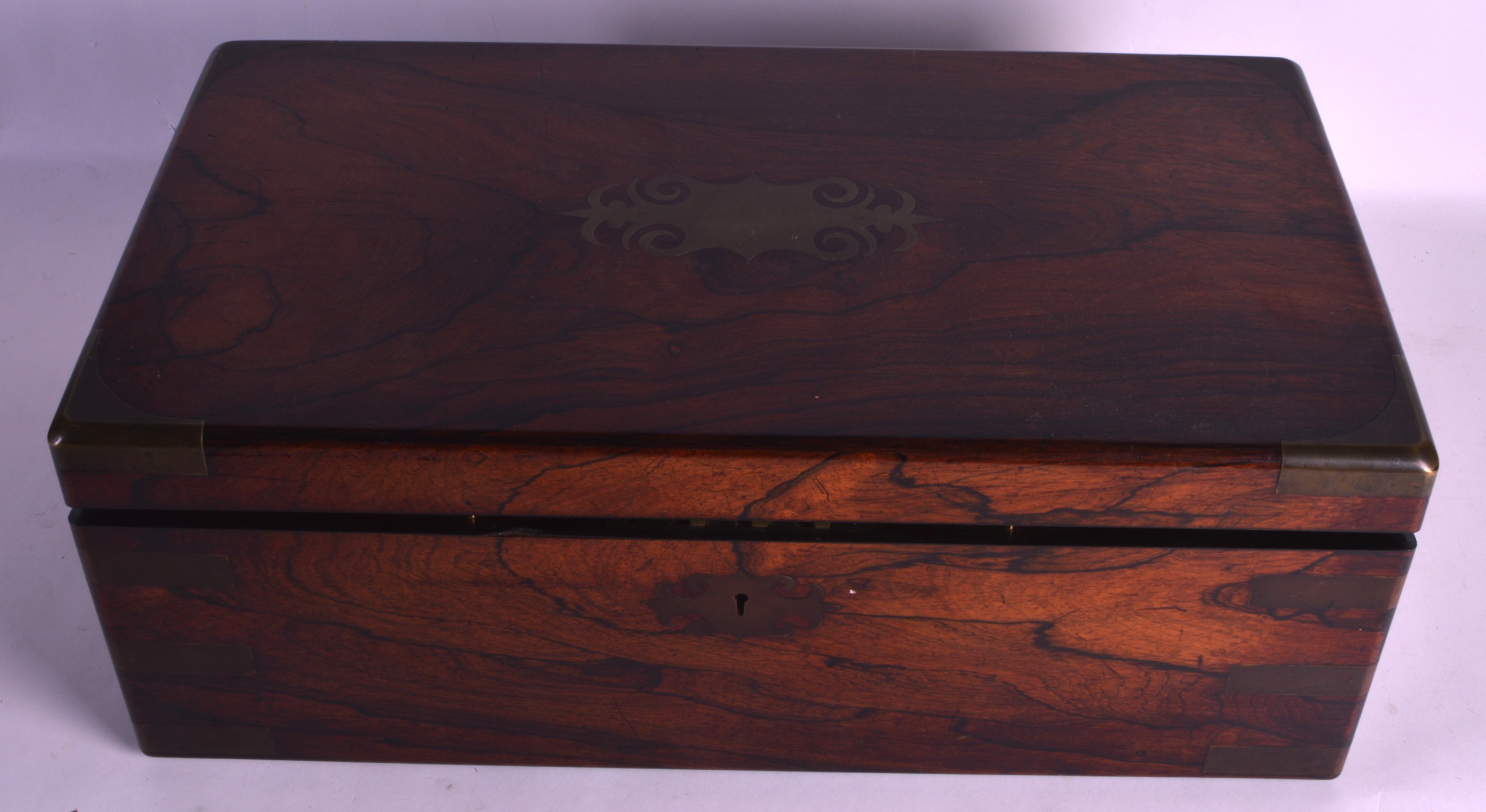 A FINE VICTORIAN SCOTTISH CARVED ROSEWOOD WRITING BOX with brass inlay, the top rising to reveal a