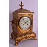 A 19TH CENTURY FRENCH BRASS MANTEL CLOCK with white dial, the case embellished with scrolling