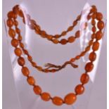 AN EARLY 20TH CENTURY AMBER NECKLACE of graduated form. 38 grams. 3Ft long overall.