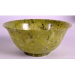 AN EARLY 20TH CENTURY CHINESE CARVED HARDSTONE BOWL with natural inclusions. 4.75ins diameter.