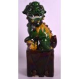 A LATE 19TH CENTURY CHINESE GREEN GLAZED DOG OF FOE upon a brown glazed pillar. 11.5ins high.