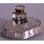 A 19TH CENTURY MOTHER OF PEARL INKWELL with pen rest. 5.25ins wide.