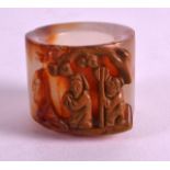 A CHINESE CARVED AGATE ARCHERS RING 20th Century, decorated with two figures. 1.25ins wide.