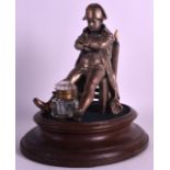 AN UNUSUAL 19TH CENTURY NAPOLEONIC INKWELL modelled as Napoleon seated upon a ivory capped chair.