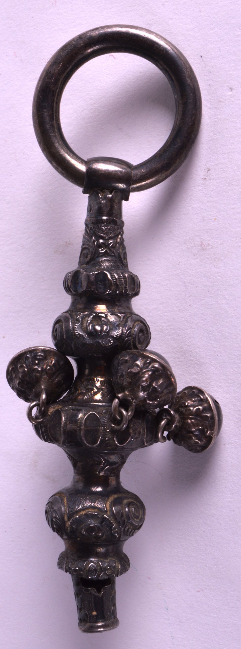 A VICTORIAN SILVER CHILDS RATTLE decorated in relief with flowers. 5.25ins long.