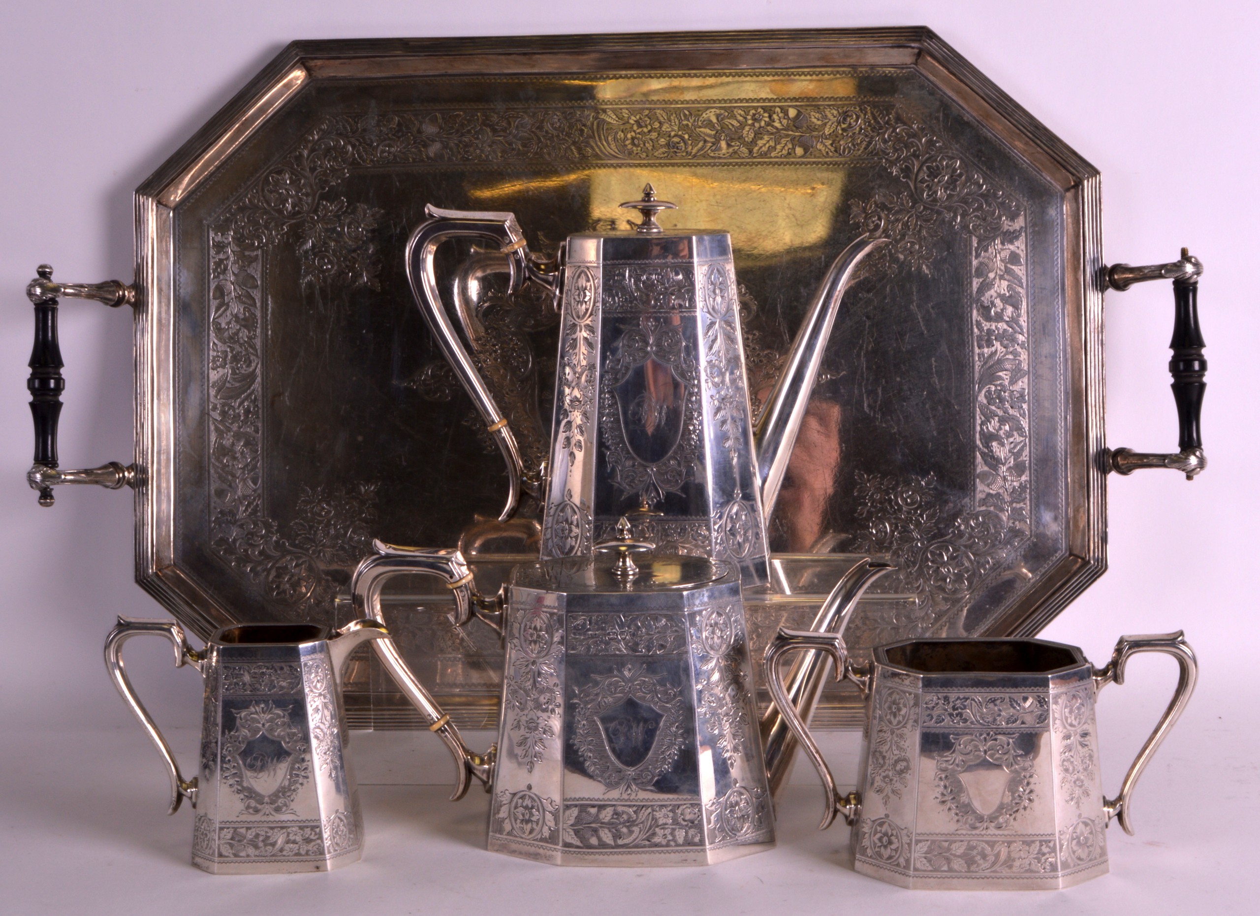 A FINE LATE VICTORIAN FIVE PIECE SILVER TEASET ON STAND incise all over with scrolling motifs and