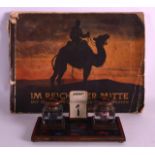 A 1930S FRENCH ENAMELLED GENTLEMANS DESK STAND together with an unusual book of German cigarette