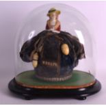 A VICTORIAN CHINA HEADED DOLL contained within a glass dome, with attached thimble holders. Figure