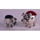 A PAIR OF STERLING SILVER PIG PIN CUSHIONS.