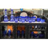 A FINE 19TH CENTURY BOHEMIAN SUITE OF BLUE FLASH GLASSWARE containing decanters, glasses, dishes,