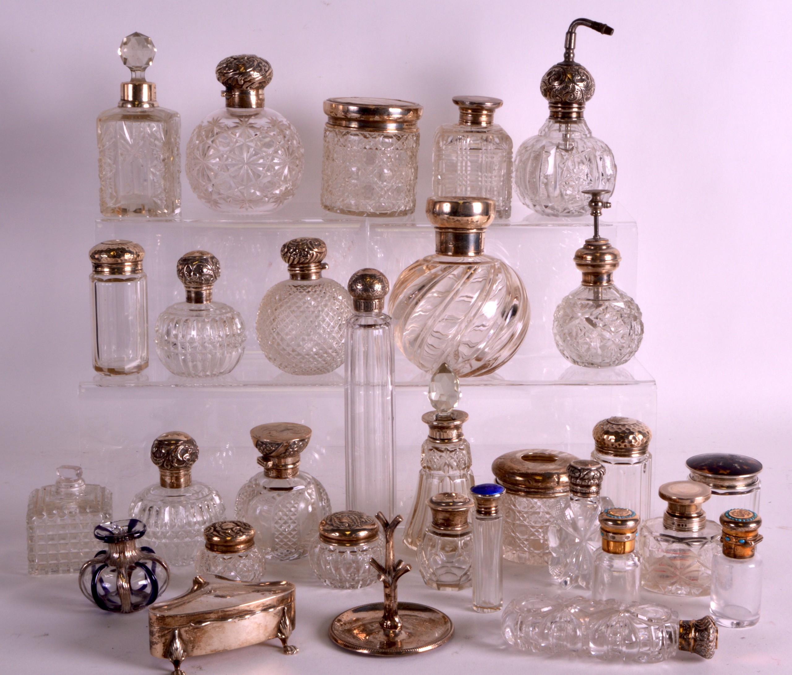 A LARGE COLLECTION OF THIRTY SILVER MOUNTED SCENT BOTTLES AND STOPPERS mostly 1900s to 1920s,