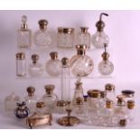 A LARGE COLLECTION OF THIRTY SILVER MOUNTED SCENT BOTTLES AND STOPPERS mostly 1900s to 1920s,