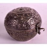 A SMALL LATE 19TH CENTURY TURKISH SILVER PILL BOX decorated in relief with flowers. 2Ins diameter.