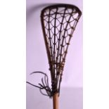 A VINTAGE LACROSSE STICK. 3Ft 8ins long.