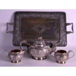 A GOOD 19TH CENTURY INDIAN SILVER TEASET ON TRAY decorated in relief with buddhistic figures in