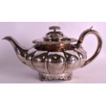 A GEORGE IV SILVER MELON SHAPED TEAPOT AND COVER with embossed lid, incised rim upon shell feet.