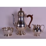 A GOOD ENGLISH SILVER THREE PIECE COFFEE SERVICE by William Comyns, comprising of teapot, sugar