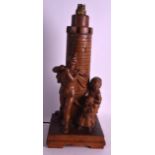 AN ARTS AND CRAFTS CARVED WOODEN TABLE LAMP unusually modelled as a pied piper upon a square form